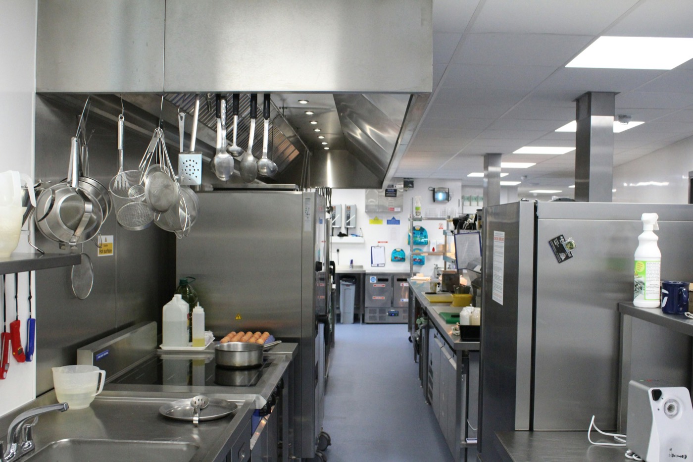 A clean commercial kitchen with stainless steel equipment