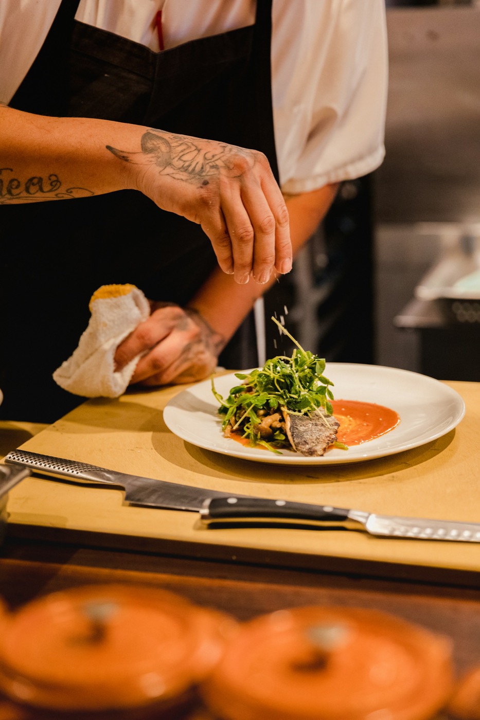 A chef plating a vegetable dish
